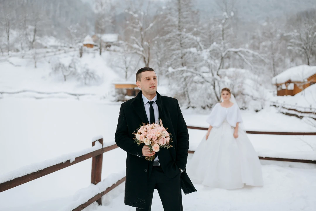 man-woman-are-standing-snow-man-holding-bouquet-flowers.jpg