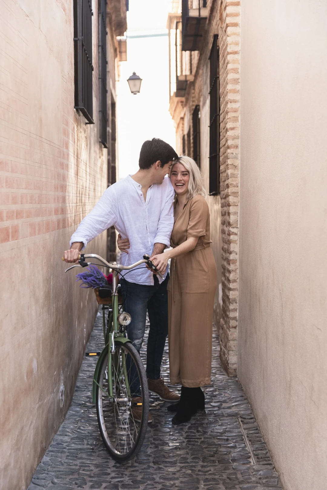 smiley-couple-posing-outdoors-with-bicycle.jpg